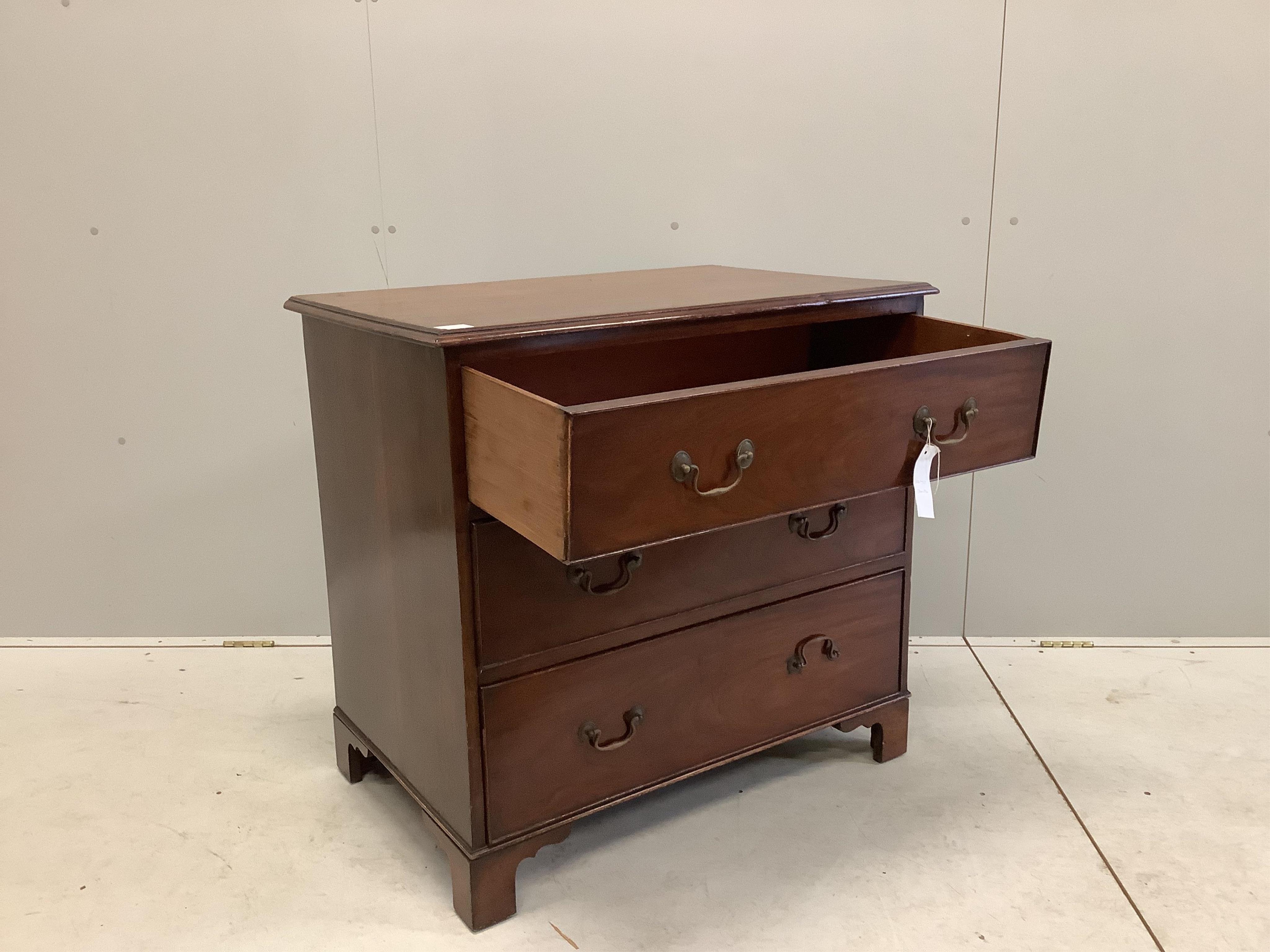 An early 20th century mahogany chest with a moulded top, three long drawers with brass loop handles and bracket feet, width 86cm, depth 56cm, height 82cm. Condition - fair to good